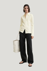 Compact knit buttoned top — model front