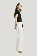 Single pleat cotton trousers — model side